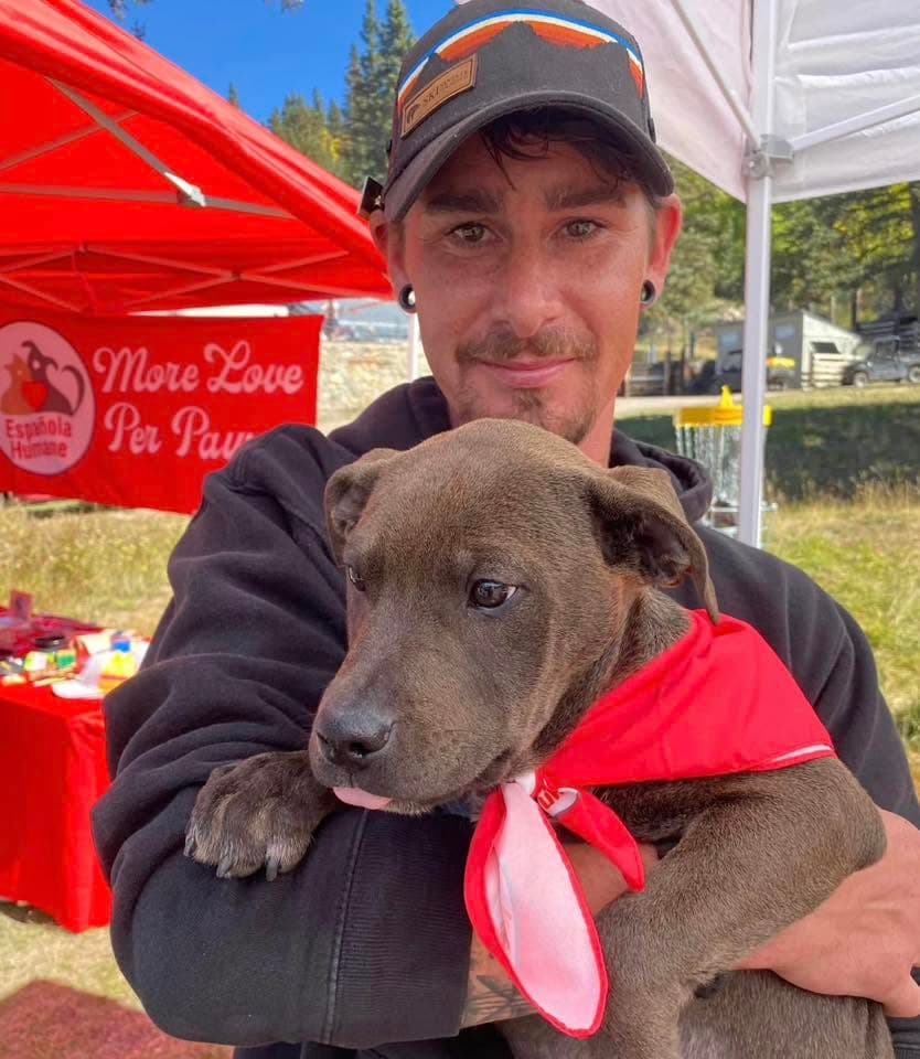 Adopted puppy in the arms of new family